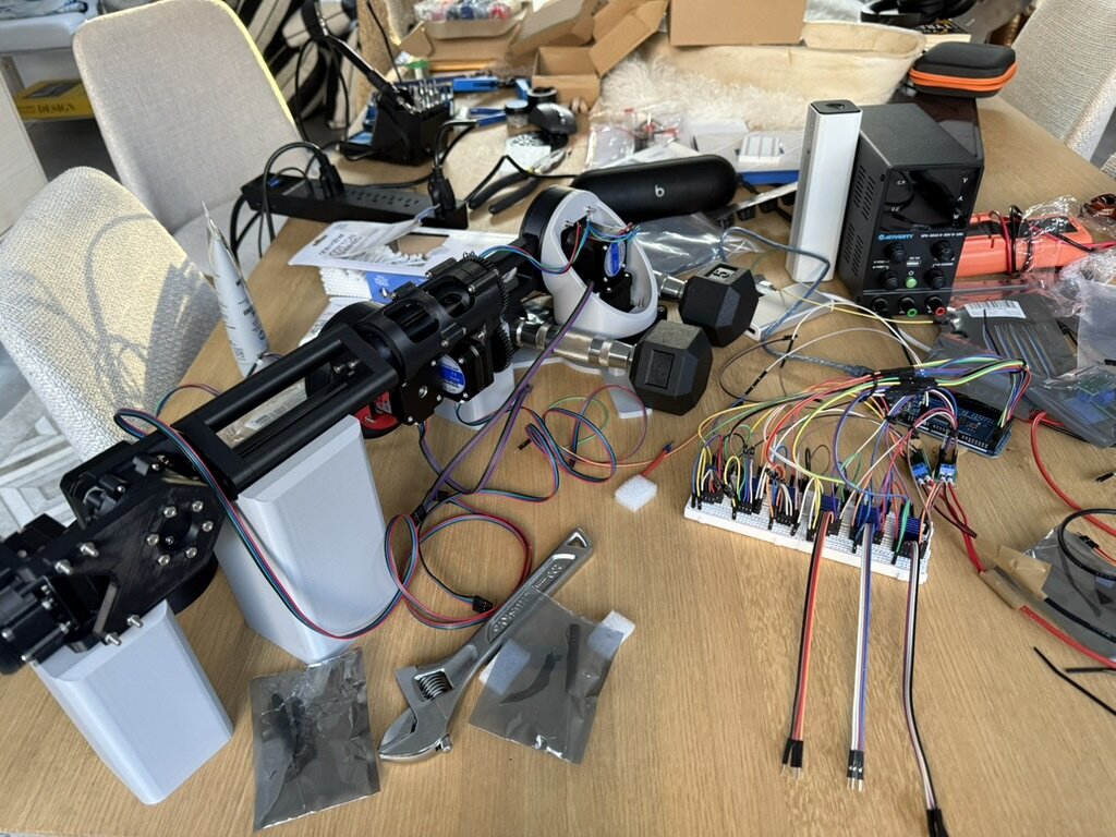 The arm on the workbench with stepper drivers and wiring